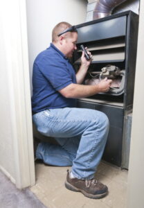 man-inspecting-interior-of-furnace