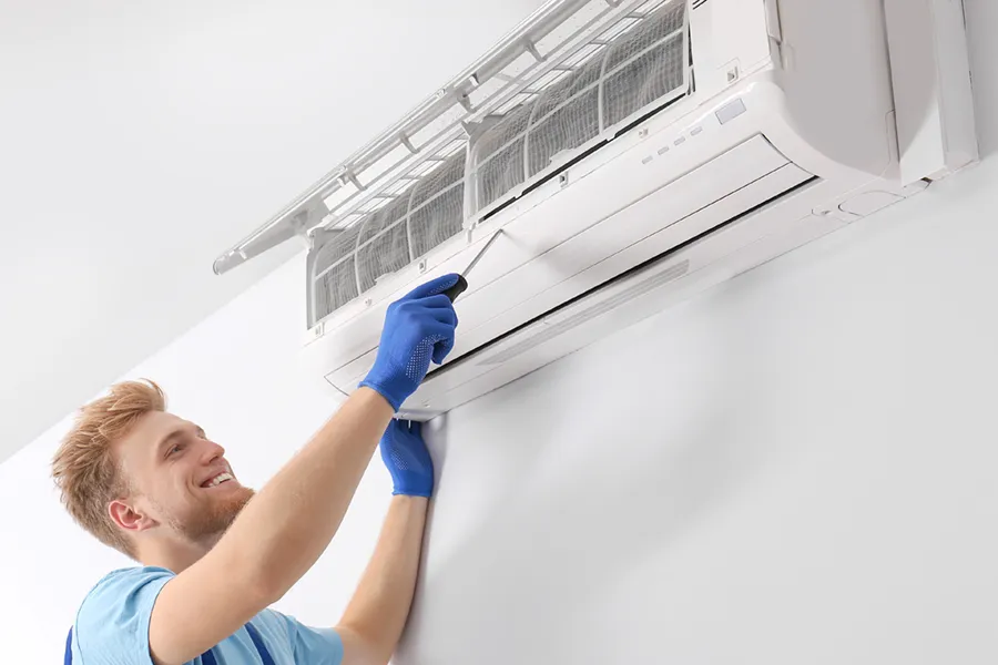 An HVAC technician servicing a ductless heat pump.