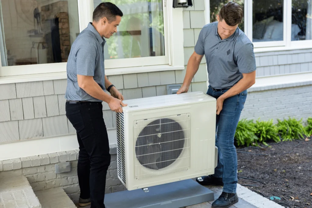 Two HVAC Install Technicians installing a system outdoors