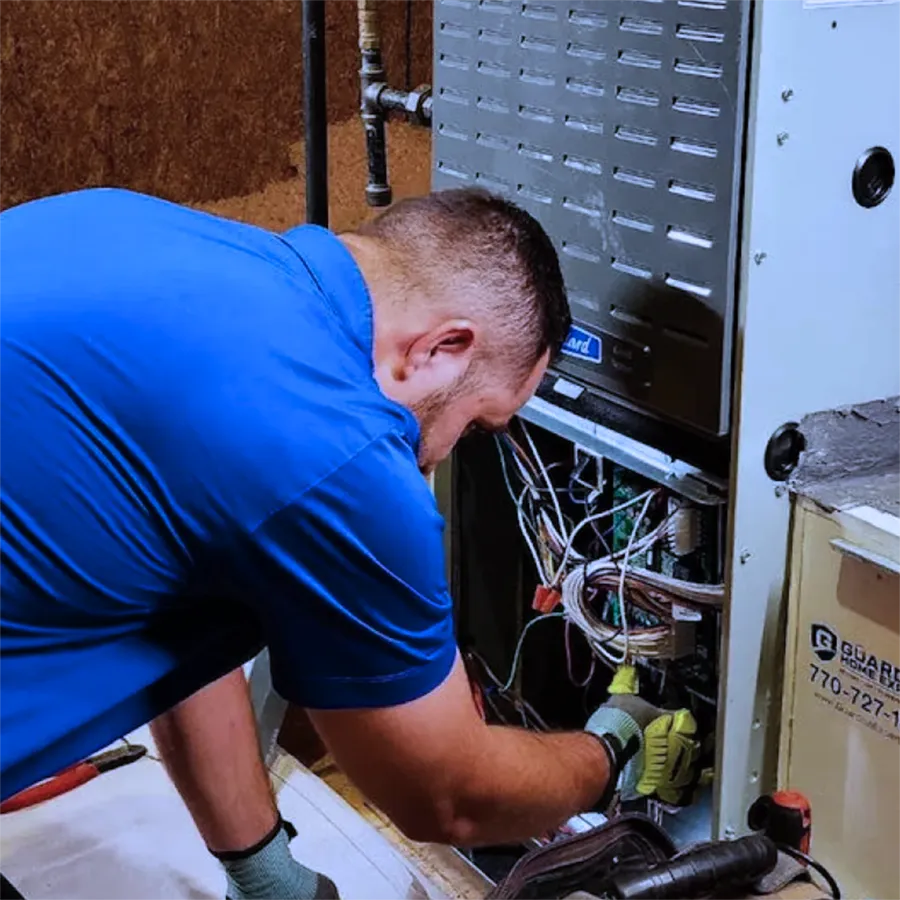 A Meyers Heating + Air technician repairing a residential furnace.