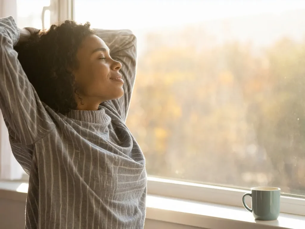 Woman looking out of window in Colorado Springs home