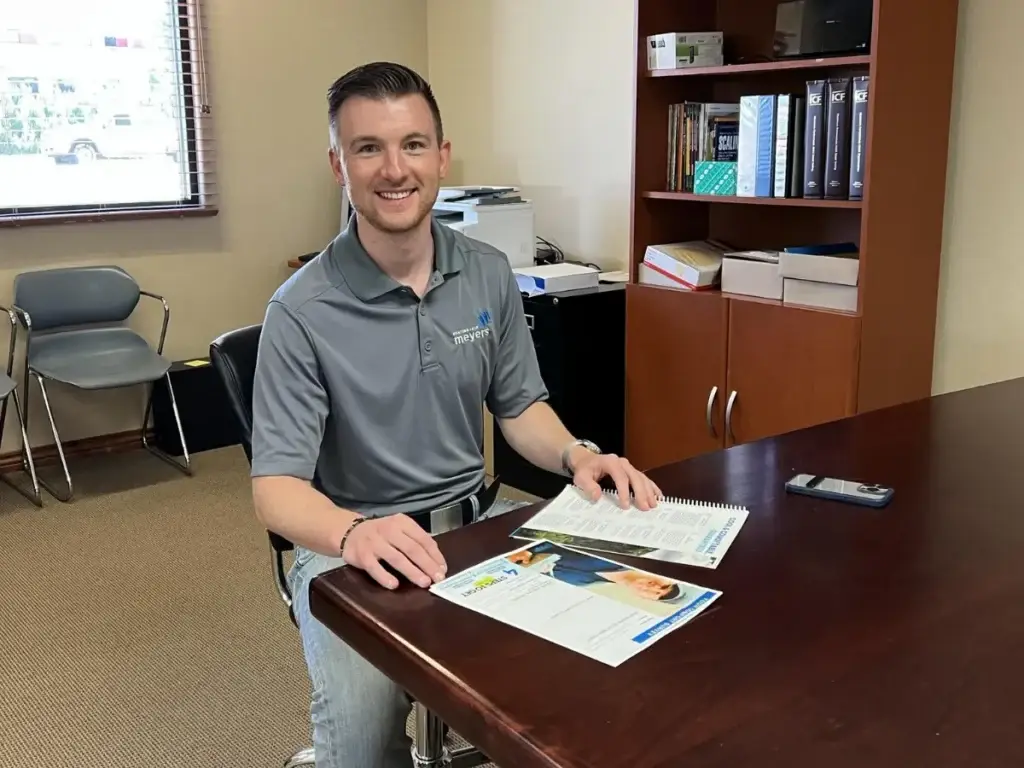 Meyers team member sitting at desk smiling
